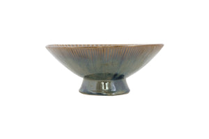 Ceramic bowl with ribbed texture on a white background