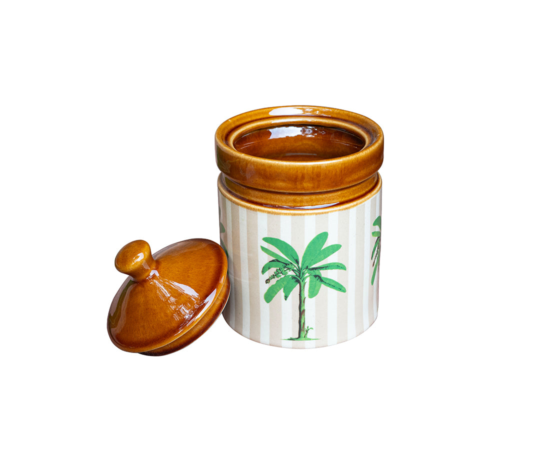 Ceramic jar with a lid featuring palm tree designs on a white background
