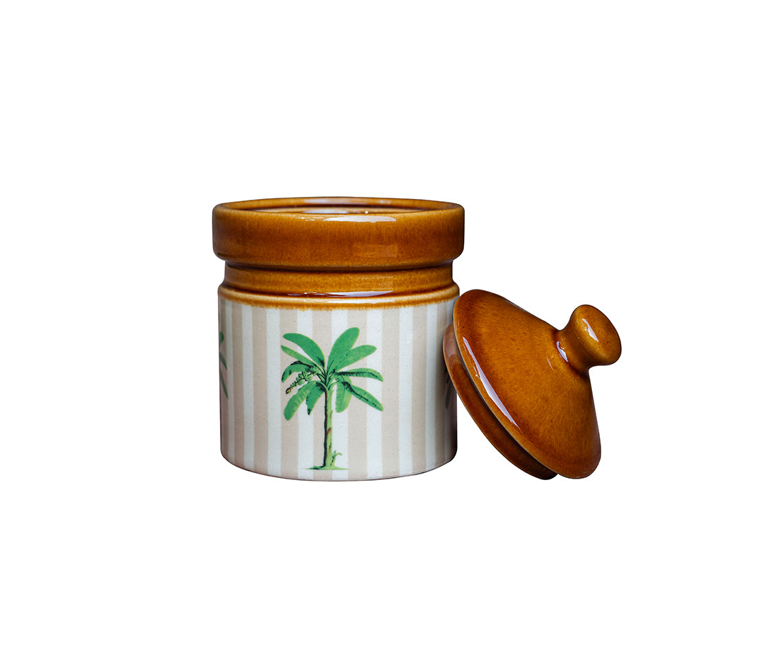Ceramic jar with striped design and palm tree illustration on a white background