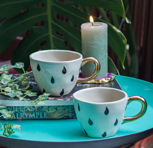 Black and White earthenware mugs with gold-plated handles
