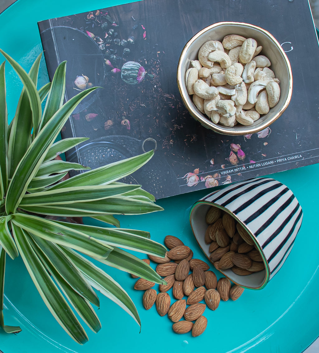 Striped earthenware bowls for serving dry fruits and nuts