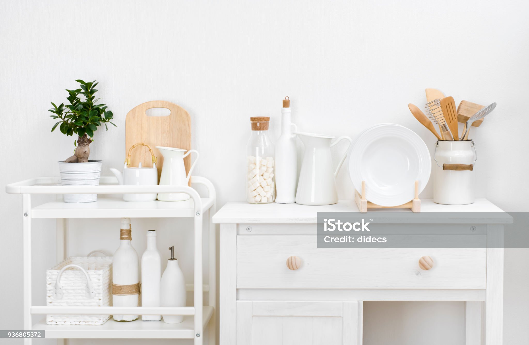 Various kitchen utensils and dishware with elegant vintage white furniture